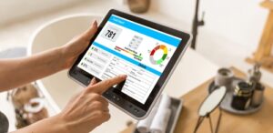 A person using a tablet to check their credit score indicating What Do Landlords Look For In A Background Check?