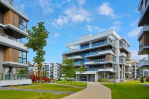 Modern residential apartment buildings with landscaped green spaces and walkways.
